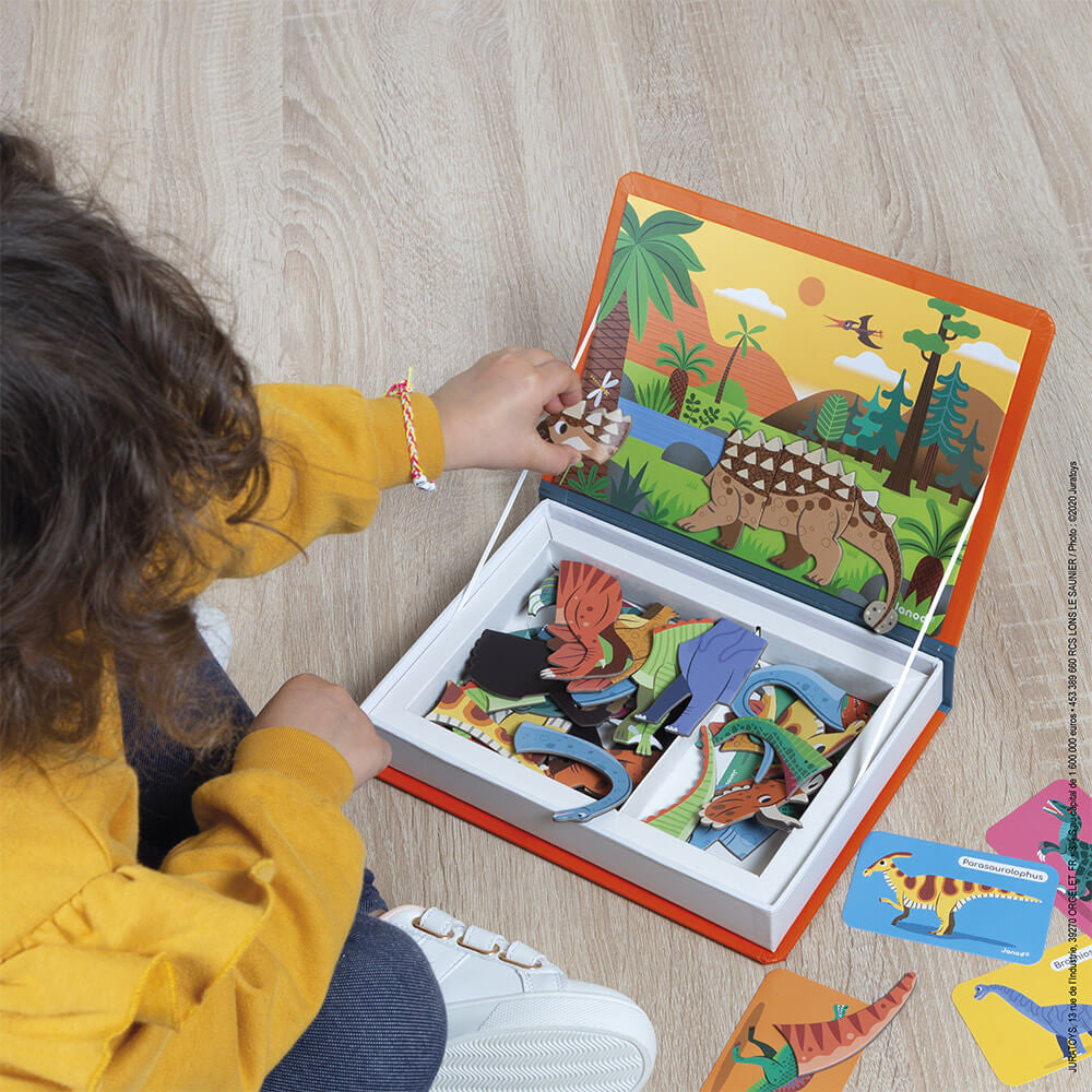 Child playing with a dinosaur puzzle set on a wooden floor