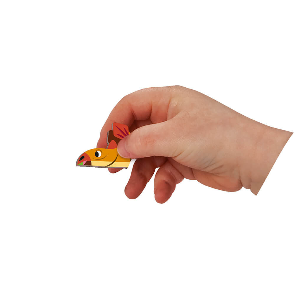 Hand holding a small fish-shaped object against a white background