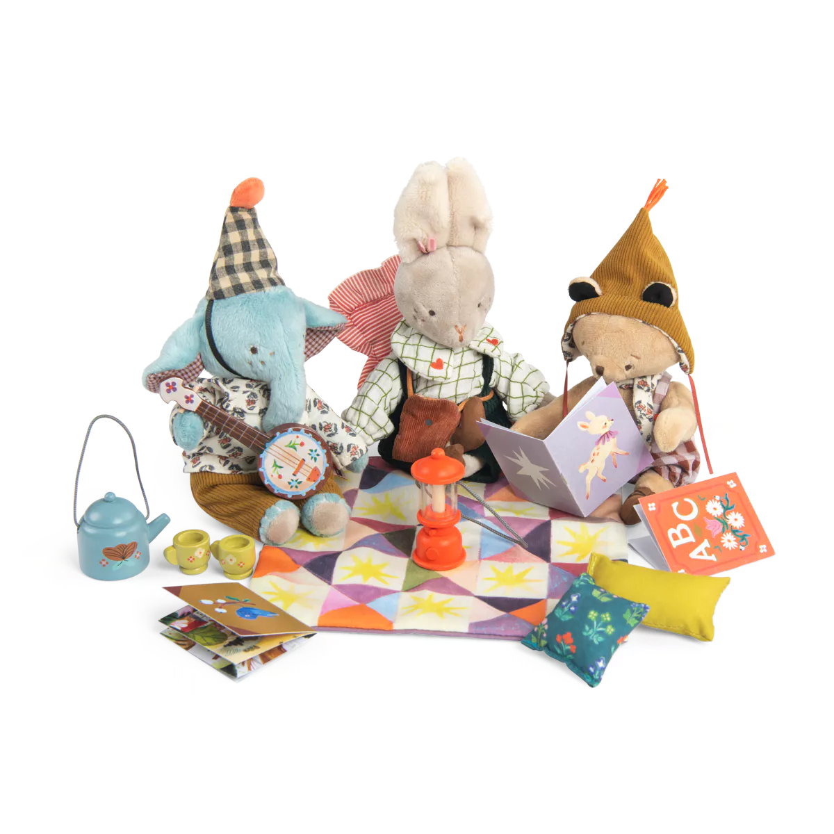 Set of plush toys and accessories on a colorful quilt with a white background