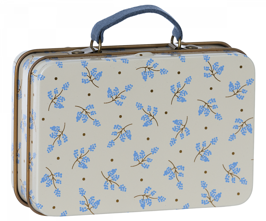 A miniature metal suitcase with a blue floral pattern on a beige background.