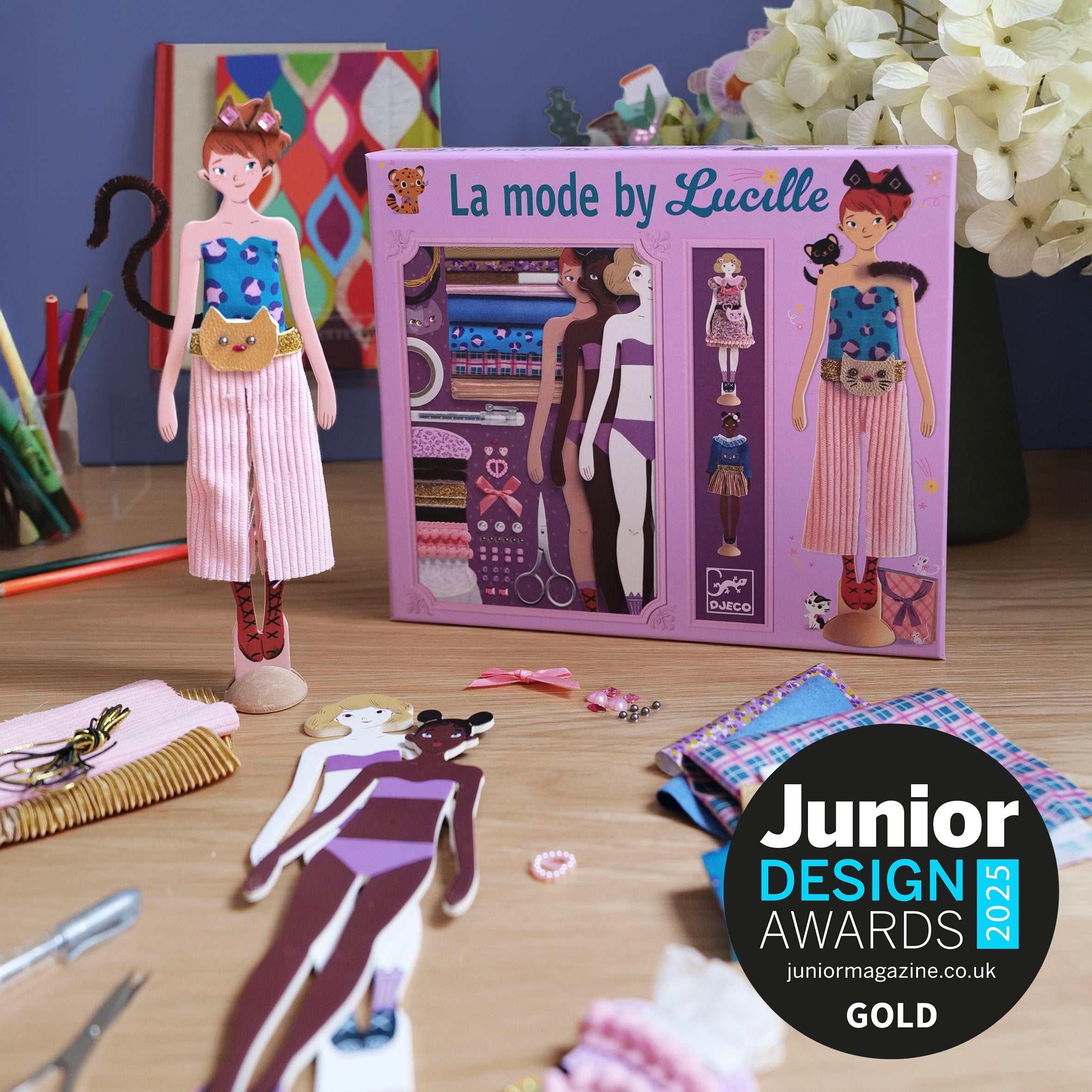 Djeco craft kit of paper doll and outfits to make with Junior Design Awards badge