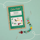 Minibeast bracelet kit with packaging on a light green background