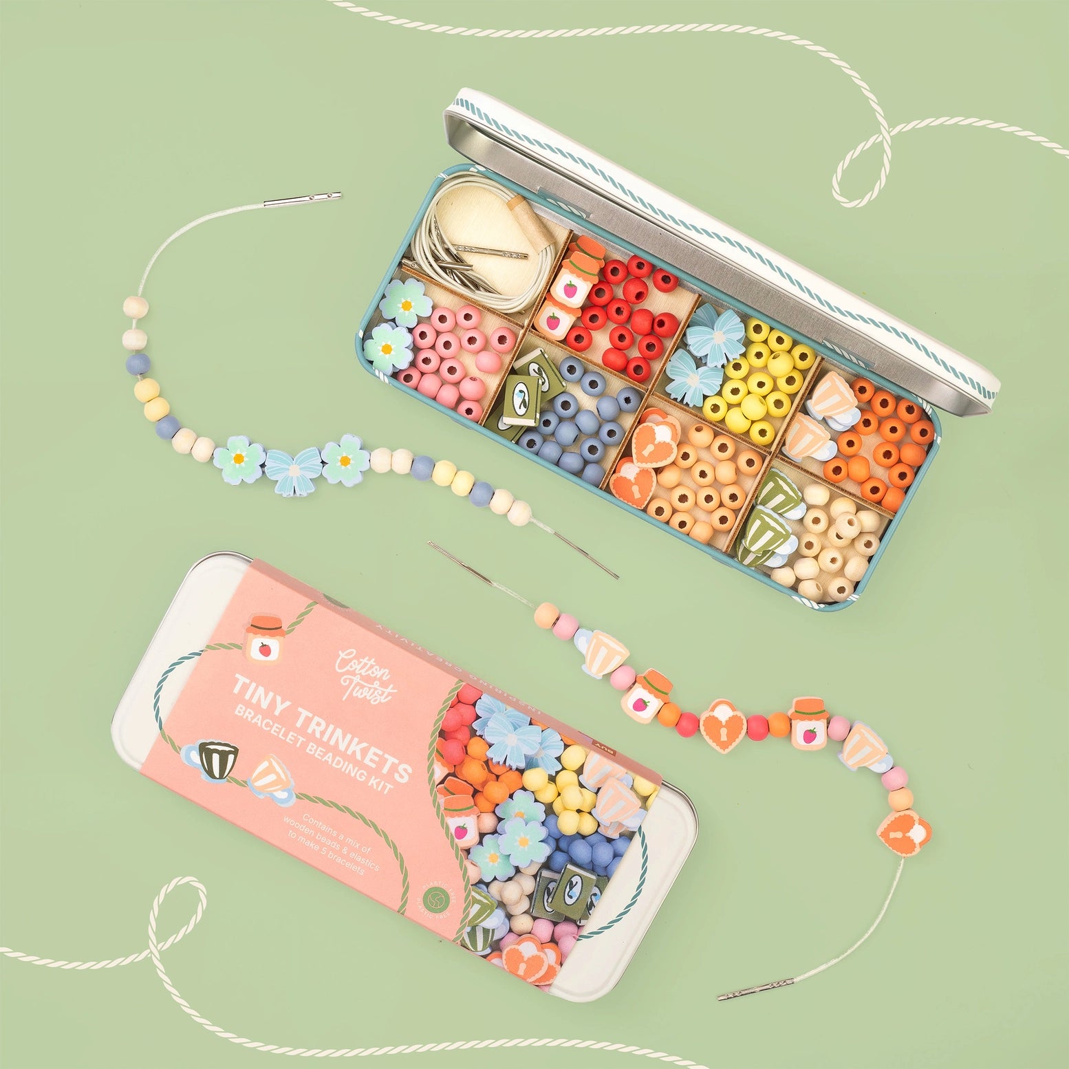 Colorful bead set with tools on a green background