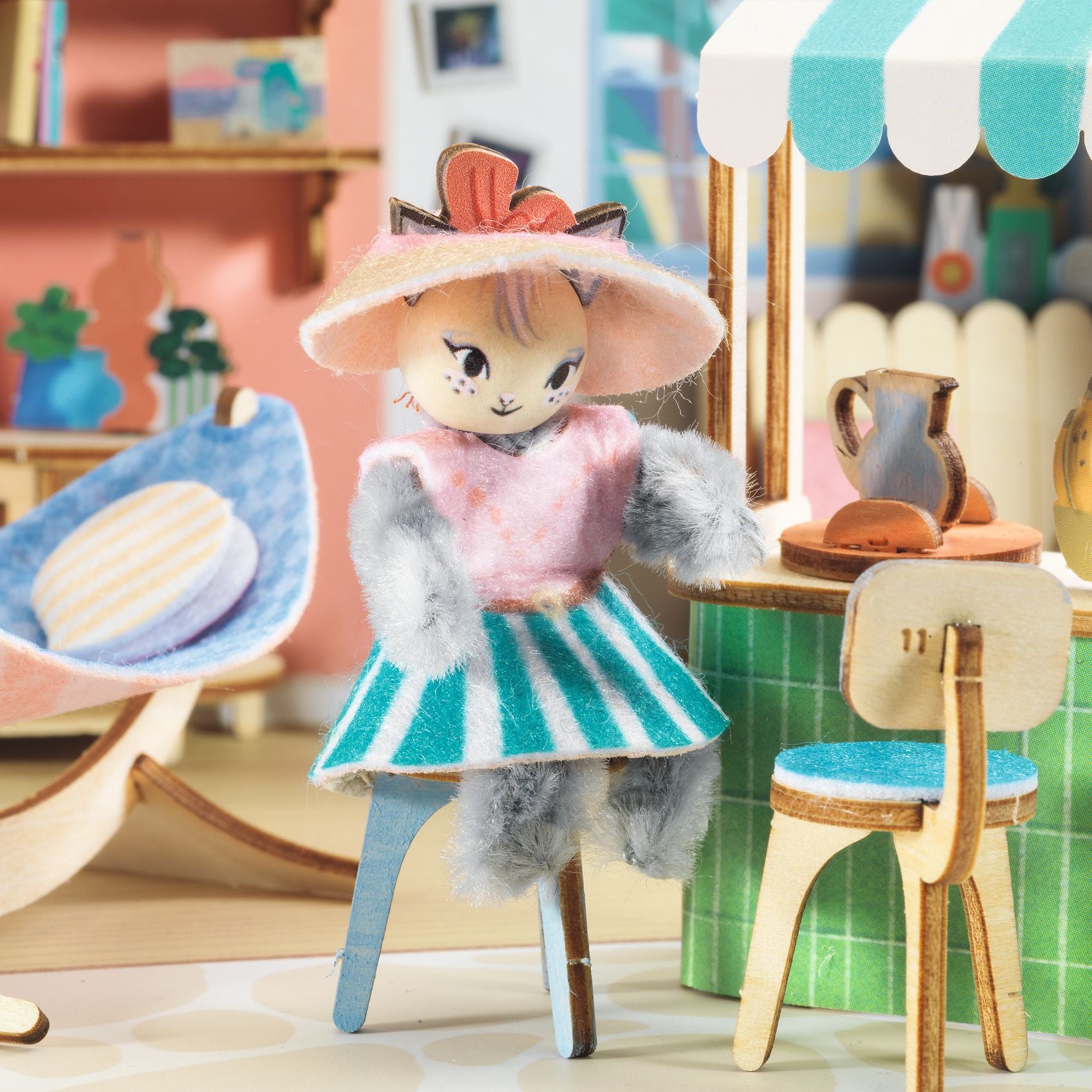 Toy figure of a girl with a hat in a miniature room setting