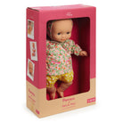 Baby doll in a pink and beige box with 'Petit Pan' branding