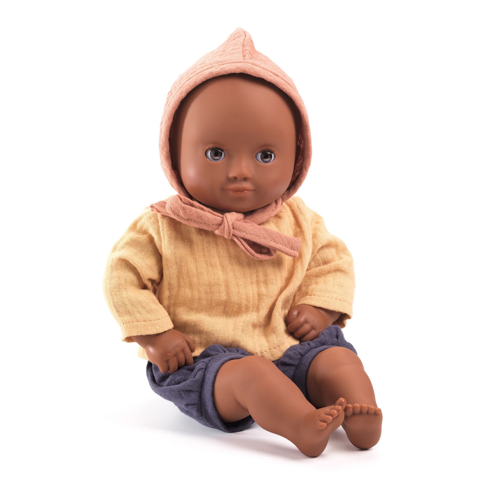 Baby doll with a pink hood and yellow outfit on a white background