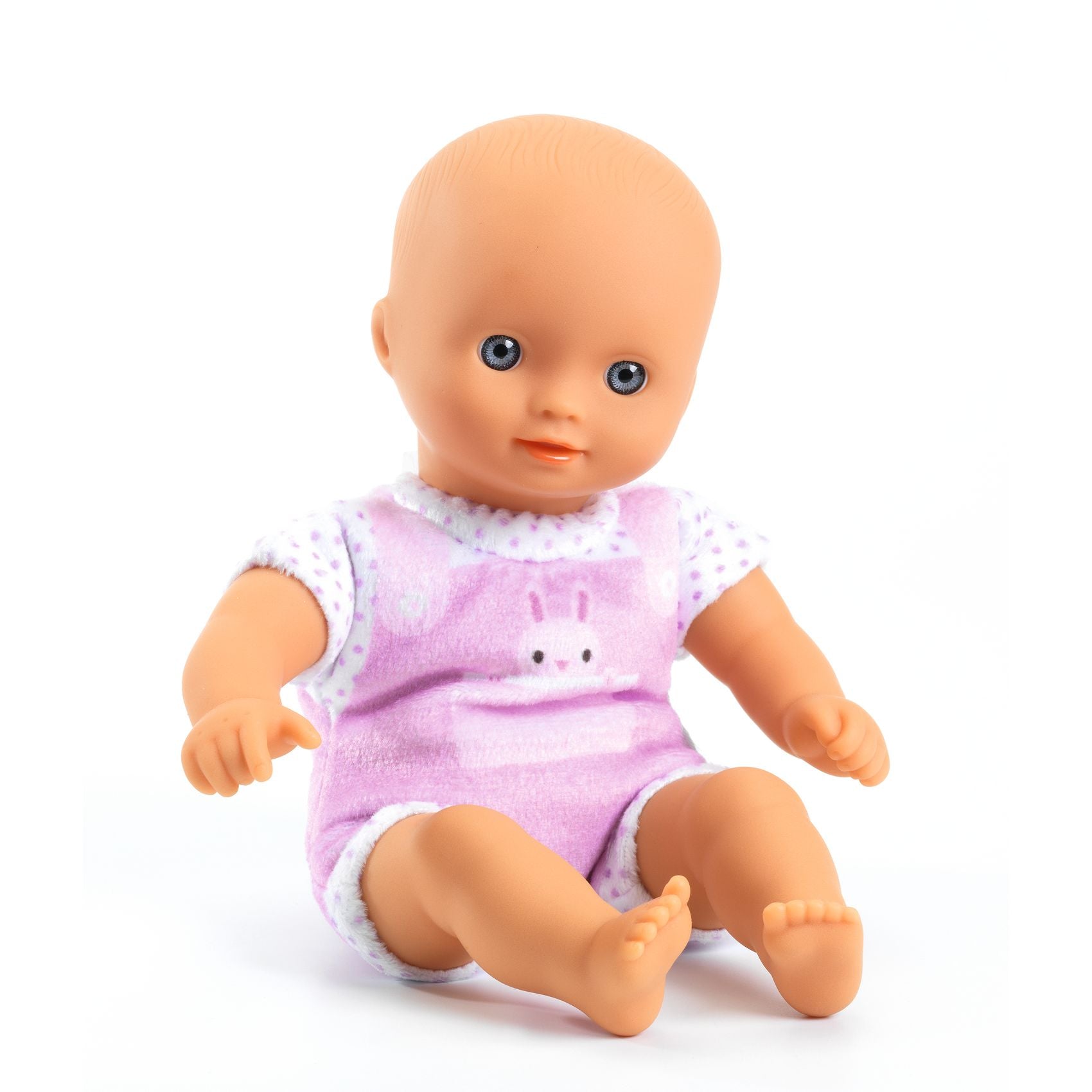 Baby doll wearing a pink outfit with a bunny design on a white background