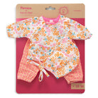 Children's floral outfit set on a pink and brown packaging background
