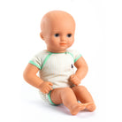 Baby doll wearing a striped onesie with green trim on a white background