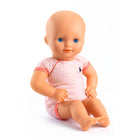 Baby doll with a pink outfit on a white background