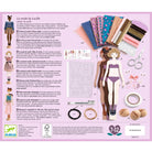Product packaging for a fashion design set with dolls, materials, and tools on a pink background.