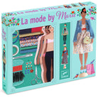 Box for 'La mode by Marie' fashion design set with dolls and sewing tools on a light blue background.