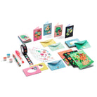 Set of colorful stationery items including cards, envelopes, note books, tape and  pens on a white background