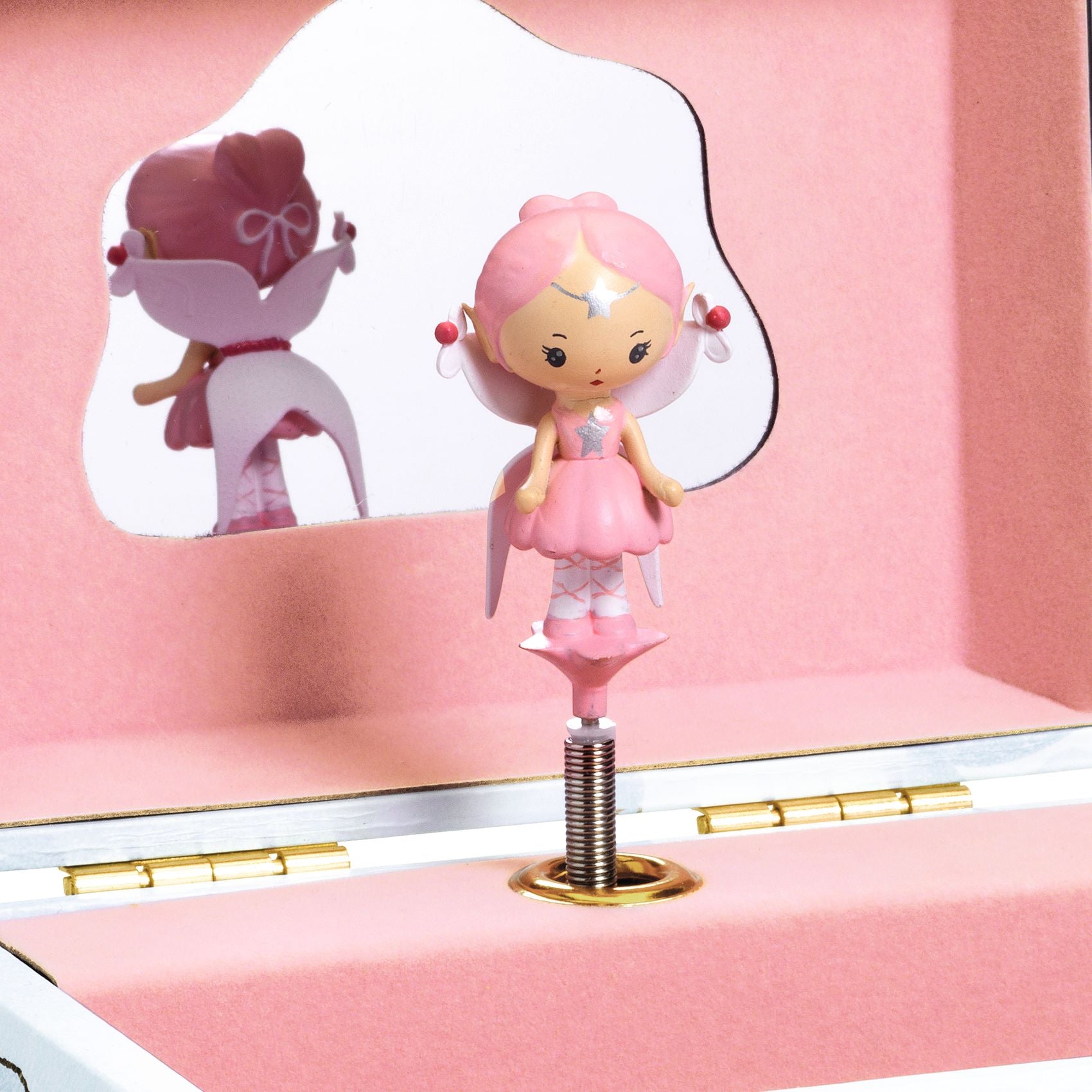 Pink fairy figurine on a stand inside a pink box with a mirror