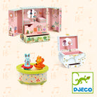 Children's toy set with music box, dollhouse, and figurines on a light background with musical notes.