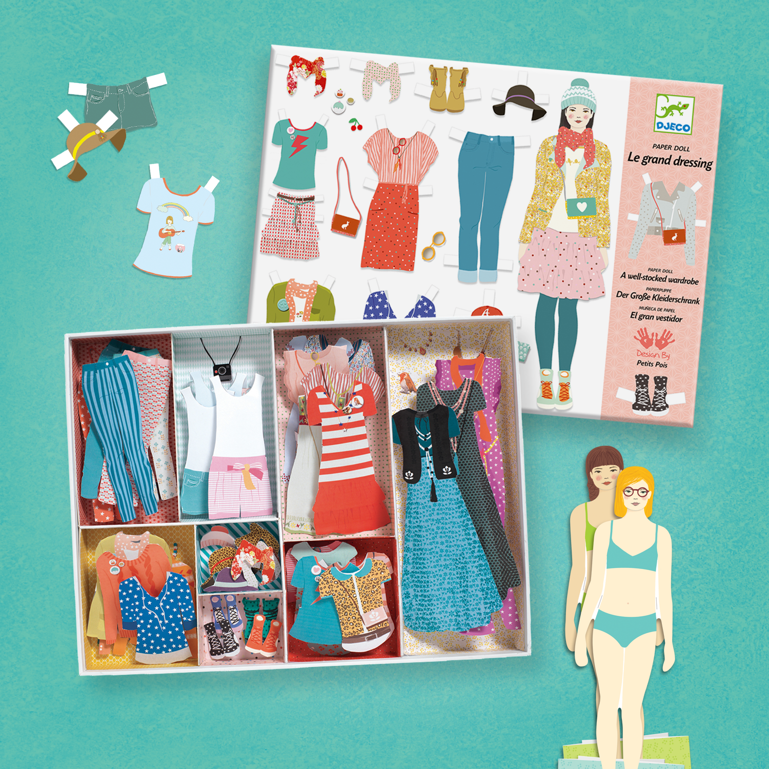 Set of paper dolls and clothing in a box on a green background