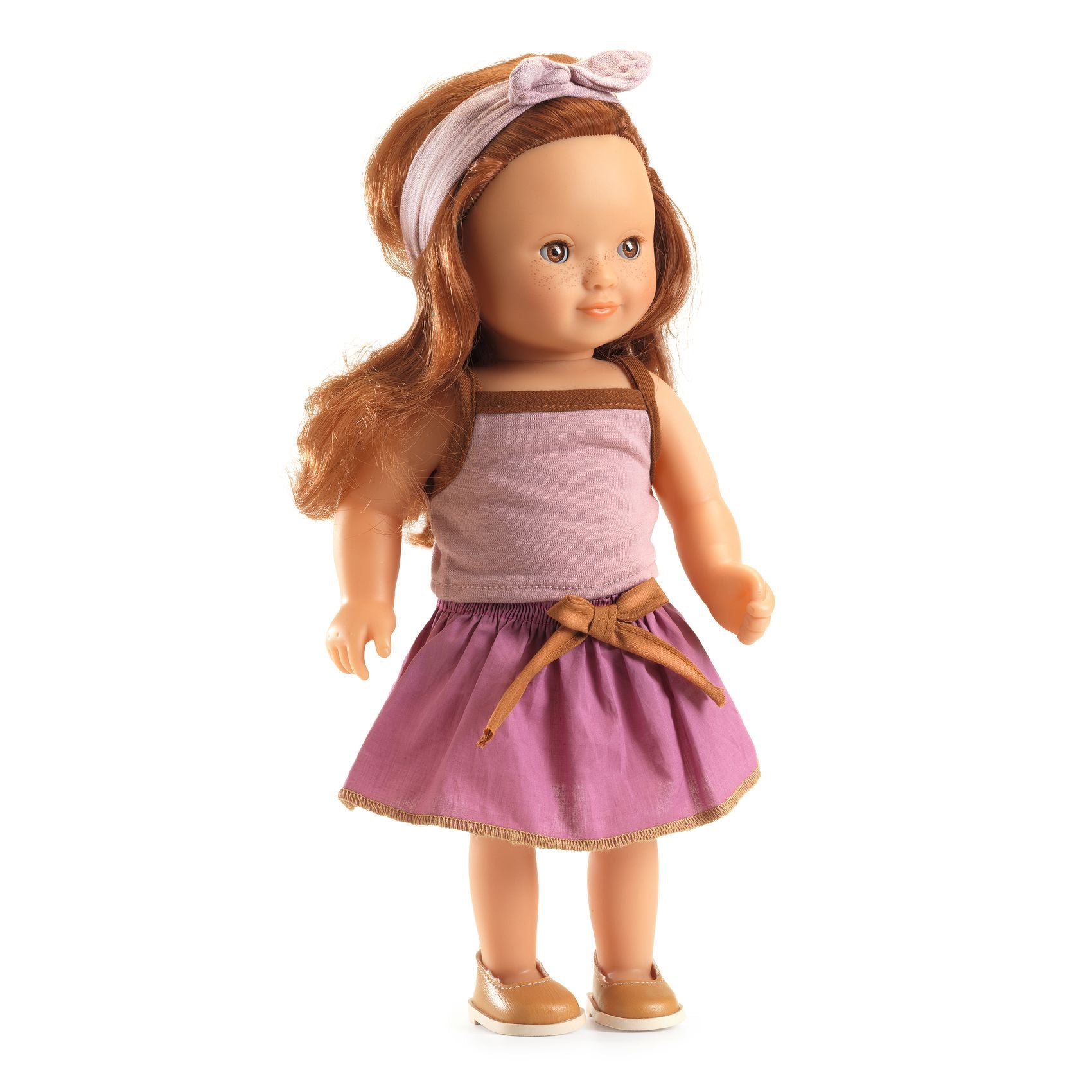 Doll with a pink dress and headband on a white background