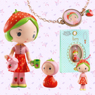 Strawberry-themed figurine with accessories on a decorative background