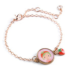 Bracelet with a character charm and strawberry on a white background