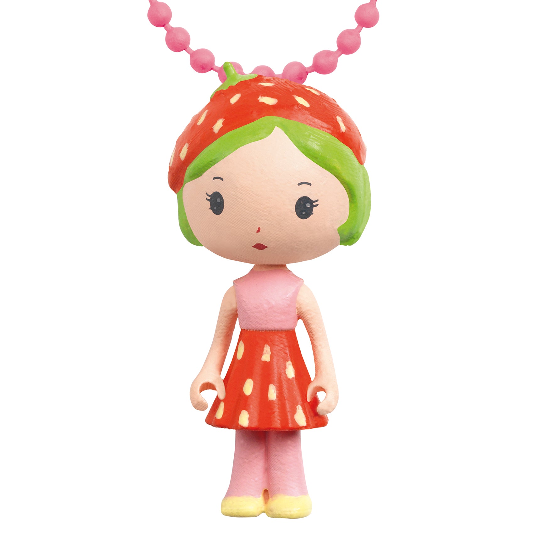 Toy figure with strawberry-themed dress and necklace on a white background