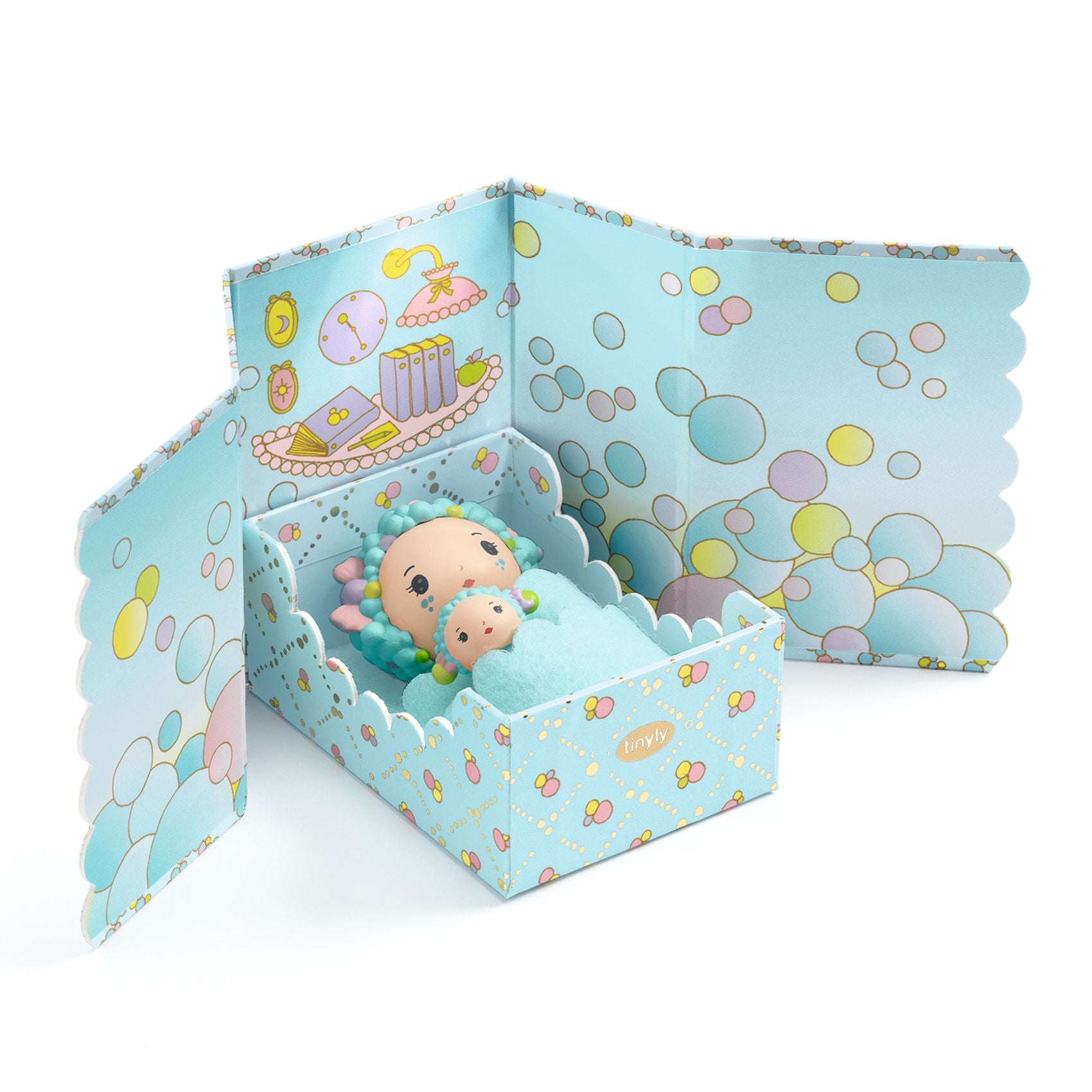 Toy figures in a decorative box with bubble-themed design on a white background
