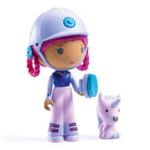 Toy figure with helmet and pink hair next to a small unicorn-like creature on a white background