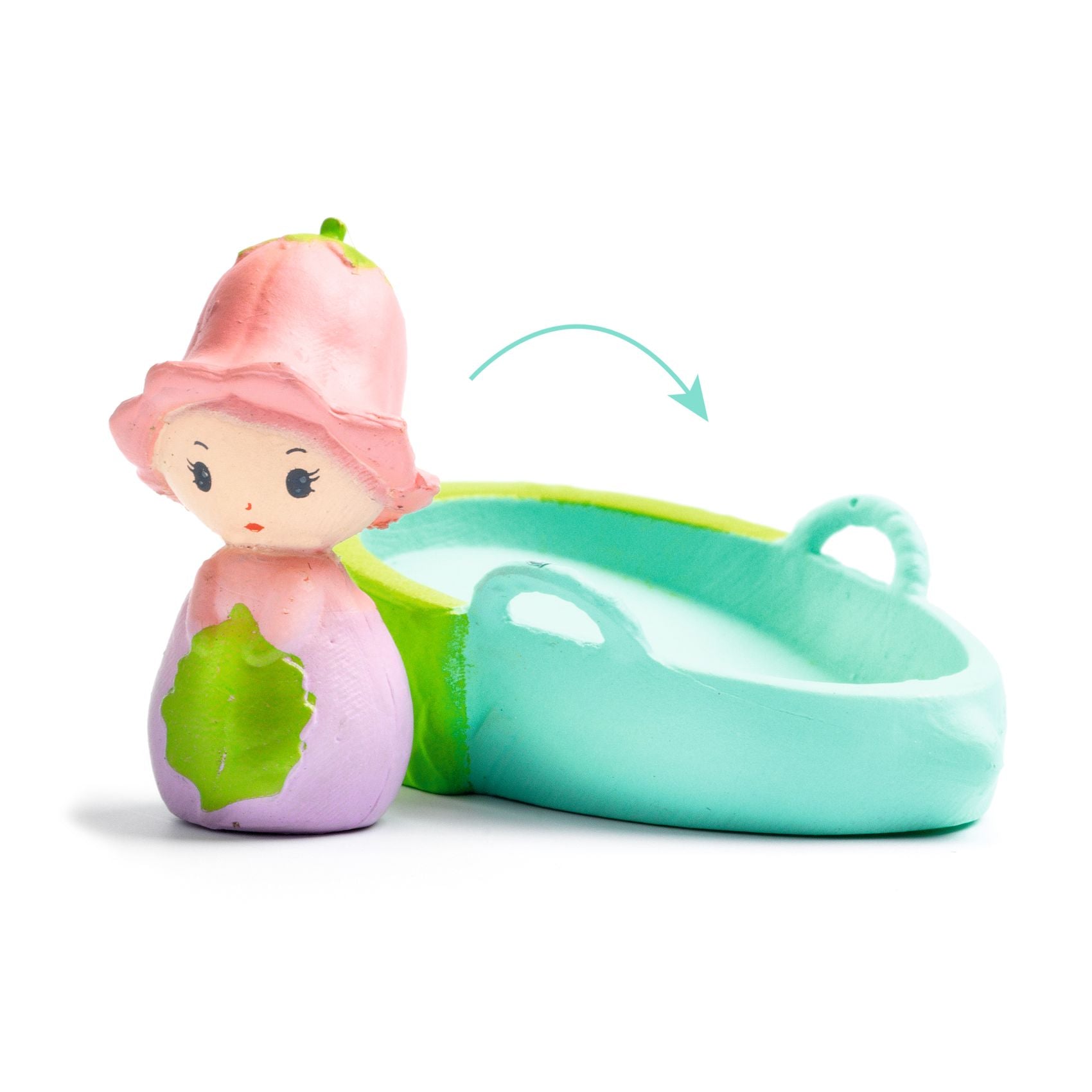 Toy figure with a pink hood and green leaf next to a teal crib on a white background
