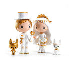 Two figurines in wedding attire with two small animal figures on a white background