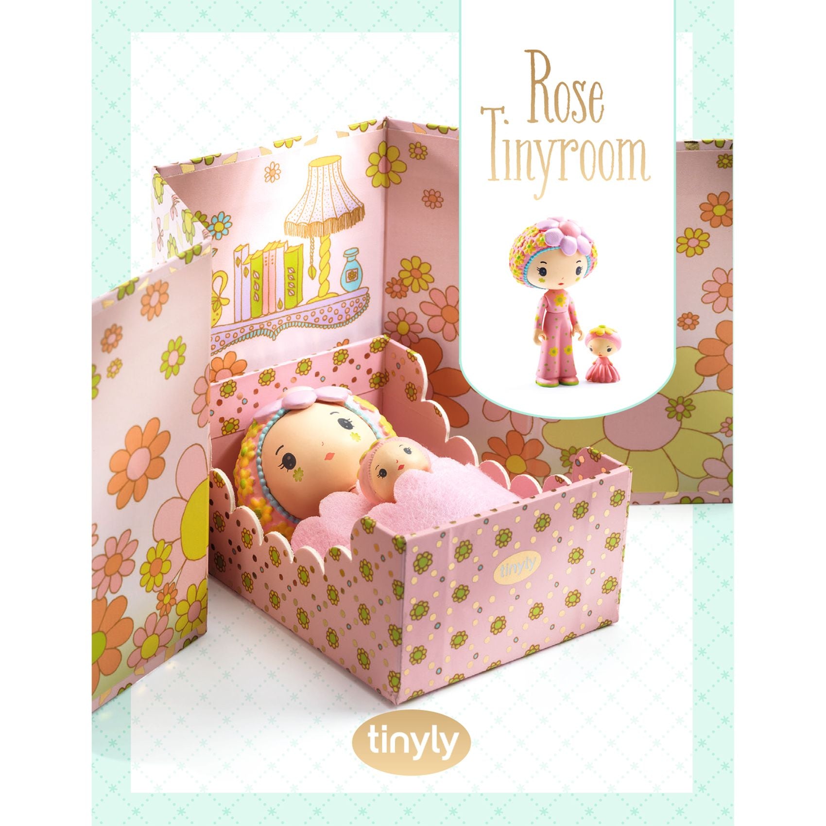 Small doll in a decorative bed with 'Rose Tinyroom' and 'tinyly' branding.
