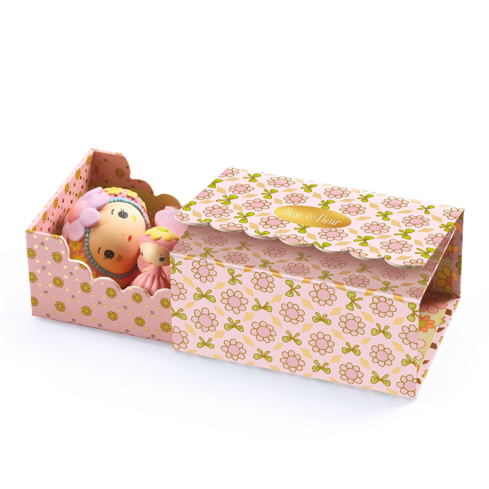 Toy figures inside a decorative box with floral pattern on a white background