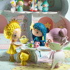 Toy figurines in a play setting with a colorful background