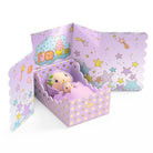Toy figures in a purple bed with star patterns on a white background