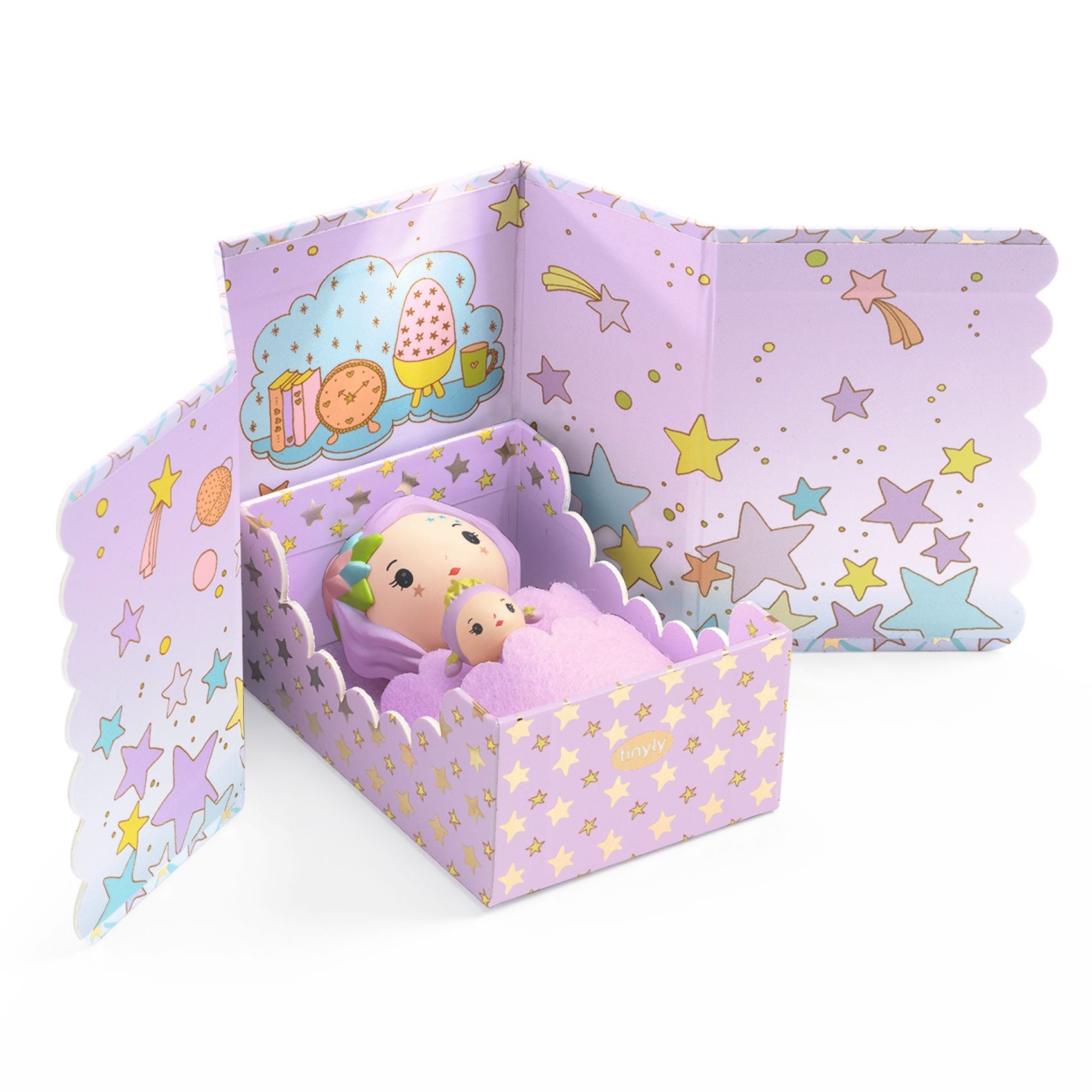 Toy figures in a purple bed with star patterns on a white background