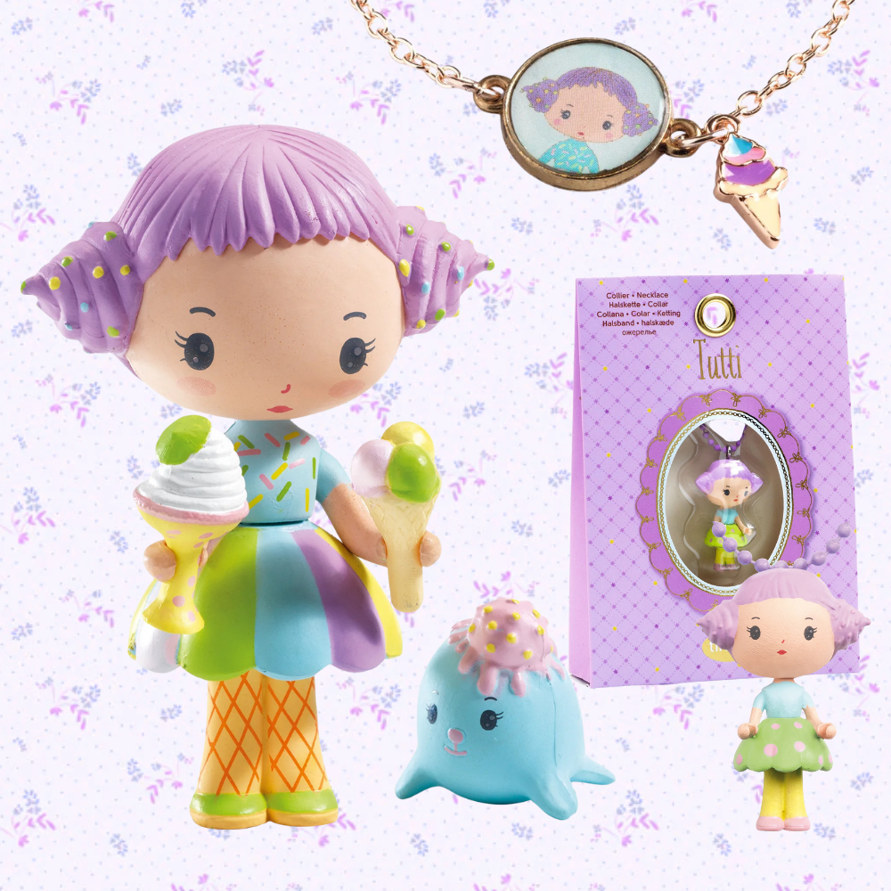 Set of colorful toys including a figurine, necklace, and packaging on a light purple background.