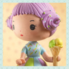 Toy figure with purple hair and colorful outfit holding an ice cream cone.