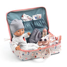 Doll with accessories in a travel bag on a white background