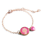 Bracelet with a pink charm featuring a cartoon character on a white background