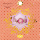 Bracelet in packaging with decorative elements on a pink background