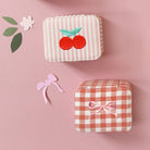 Set of small, decorative boxes with various patterns on a pink background