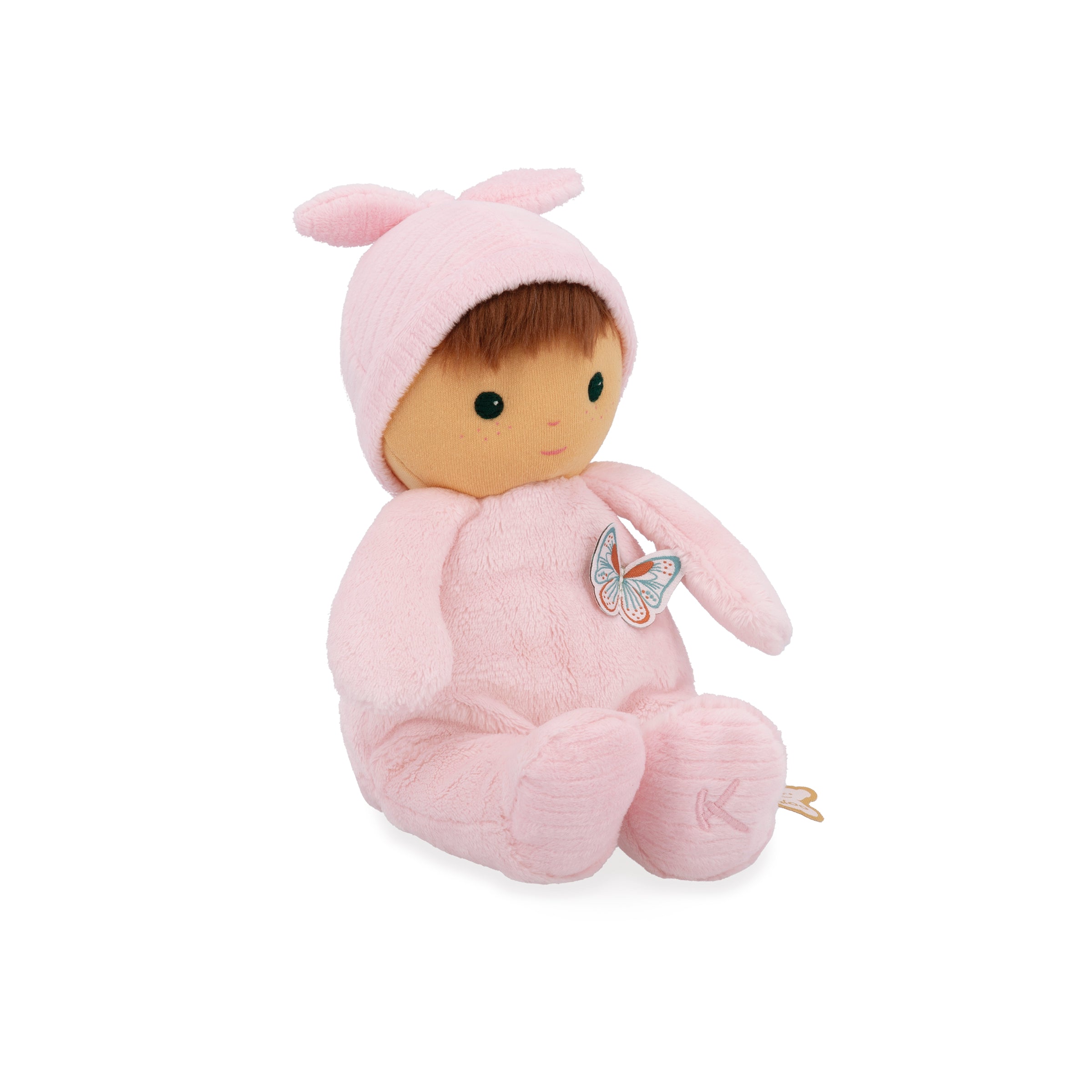 Stuffed toy in a pink outfit with a butterfly patch on a white background