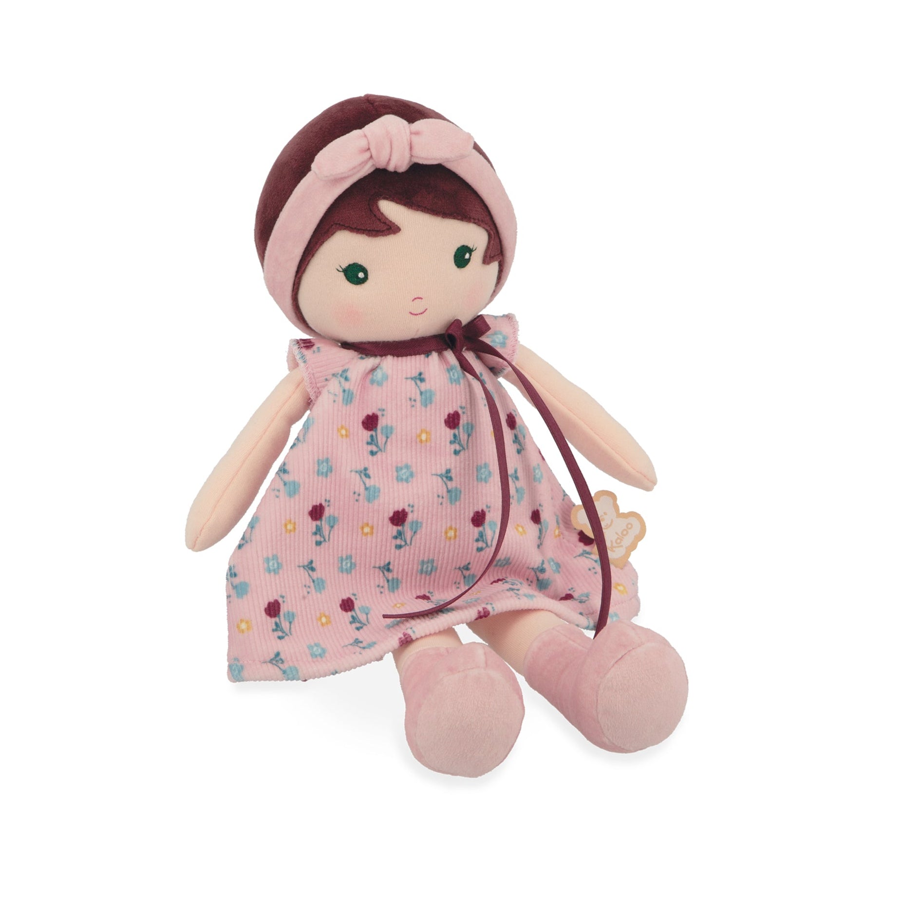 Stuffed doll with a pink dress and headband on a white background