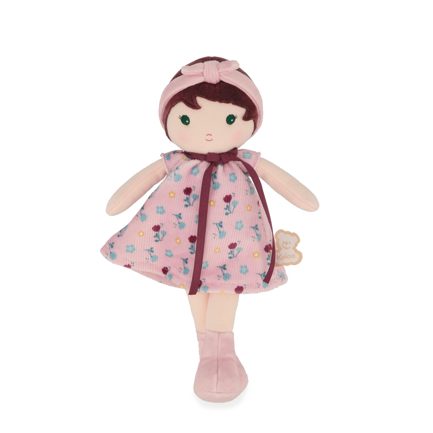 Stuffed doll with a pink floral dress and headband on a white background