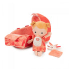 Plush toy with a red outfit and matching bag on a white background