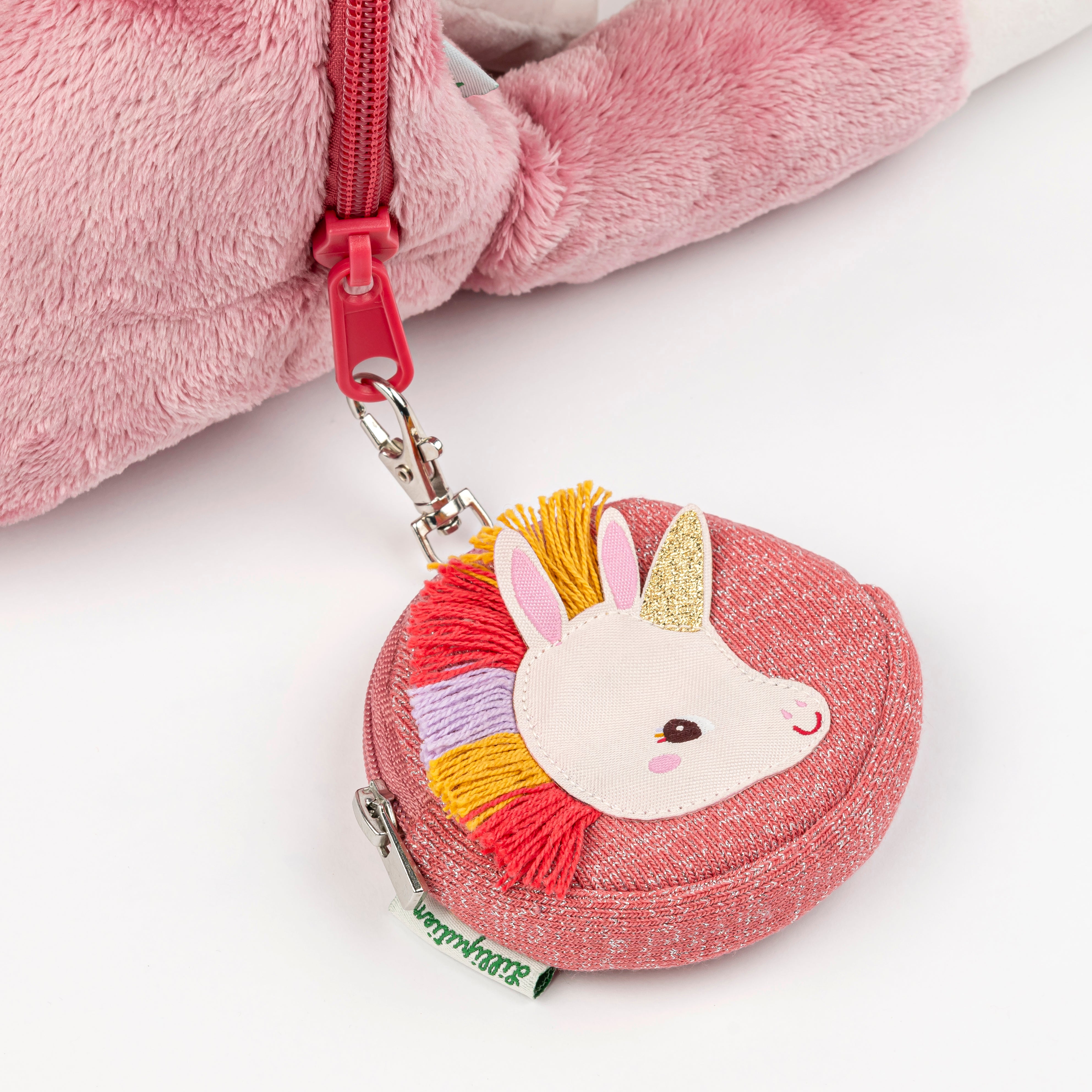Pink coin purse with unicorn design and rainbow accents on a white background