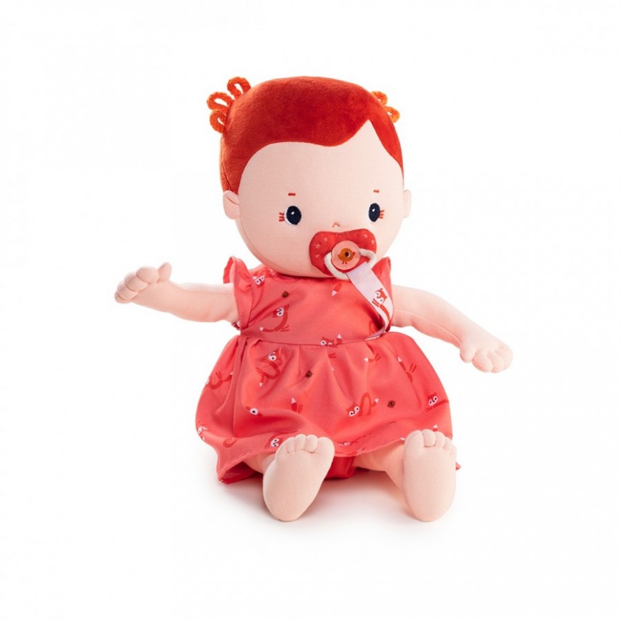 Stuffed doll with red hair and dress on a white background