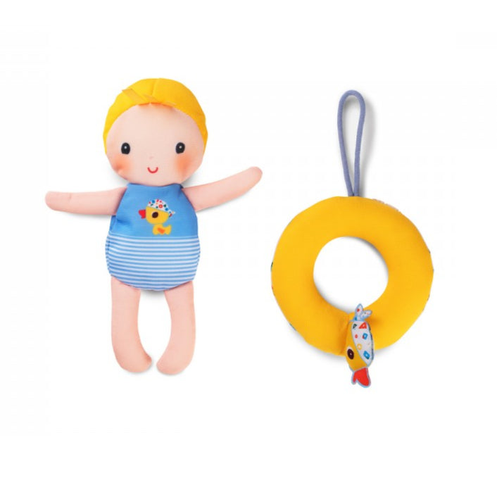 bath doll toy with yellow hair and blue swimsuit next to a yellow teething ring on a white background