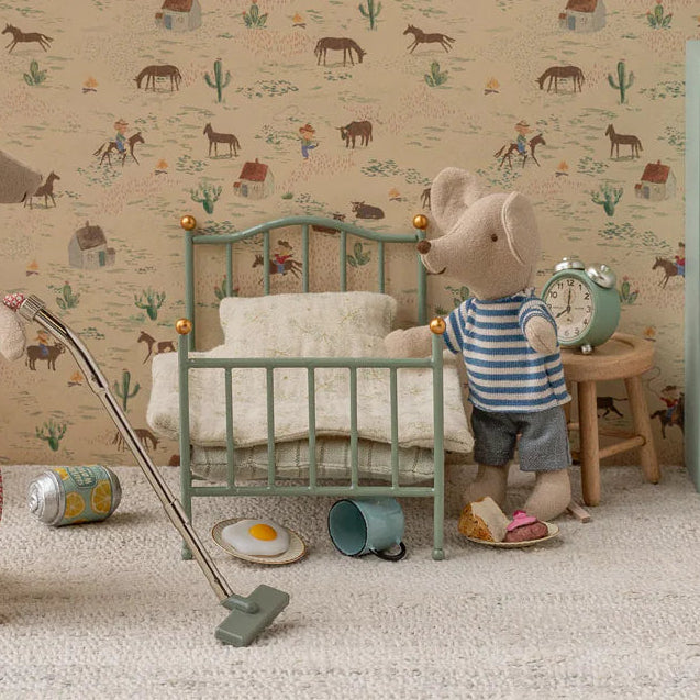 maileg dolls house Children's room with toy furniture and decor, featuring a patterned wall.