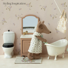 Stylized bathroom scene with a toy kangaroo, bathtub, and vanity mirror.