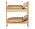 A miniature two-tier dollhouse bed frame in a light beige wood finish, furnished with two tan floral-patterned pillows and striped mattress covers, isolated on a white background.