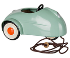 A retro-style pedal toy car in mint green with white wheels, orange centers, a black steering wheel, and a brown pull cord with a wooden knob, shown on a white background.